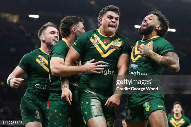 Latrell Mitchell of Australia celebrates with teammates Nathan Cleary and Josh Addo-Carr after scoring their team's sixth try during the Rugby League...