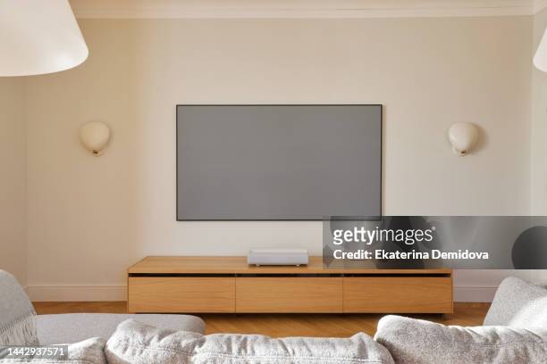 home theater interior with a compact laser projector - alexa grace stock pictures, royalty-free photos & images