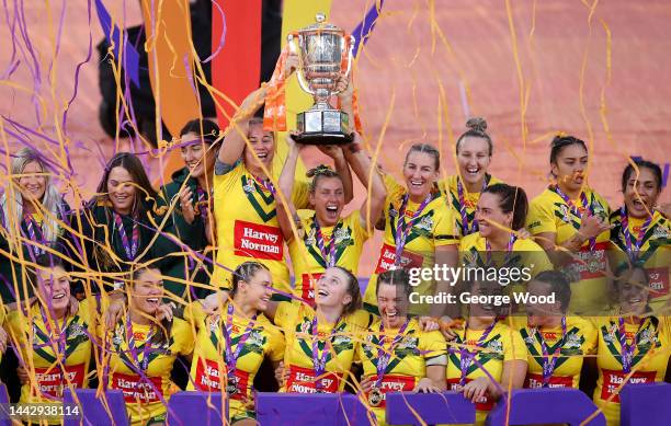 Samantha Bremner of Australia lifts the Women's Rugby League World Cup trophy with teammates following victory in Women's Rugby League World Cup...