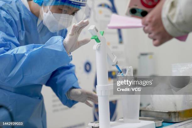 Medical worker makes preparations for an inhaled COVID-19 booster vaccination on November 17, 2022 in Beijing, China.