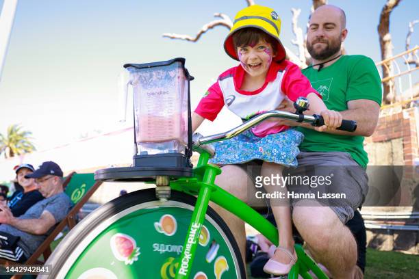 Young fan with her father ride a Woolworths smoothie bike during the Women's Big Bash League match between the Sydney Sixers and Hobart Hurricanes...