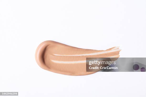 liquid foundation swirl on white background - foundation make up stock pictures, royalty-free photos & images
