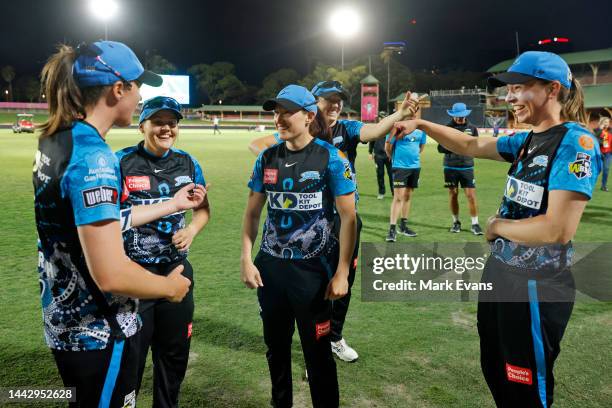 Player of the match Megan Schutt of the Strikers with team mates after the Women's Big Bash League match between the Sydney Thunder and the Adelaide...