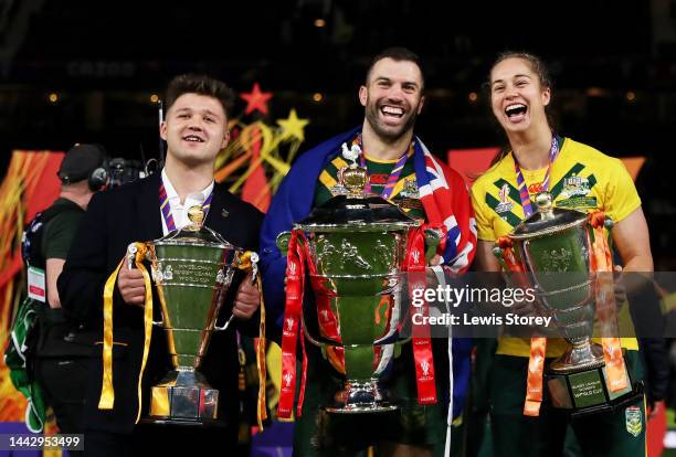 Tom Halliwell of England Wheelchair, James Tedesco of Australia and Kezie Apps of Australia pose for a photograph with their trophies after the Rugby...