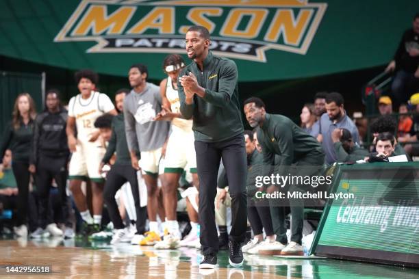 Head coach Kim English of the George Mason Patriots cheers his players during a college basketball game against the American University Eagles at...