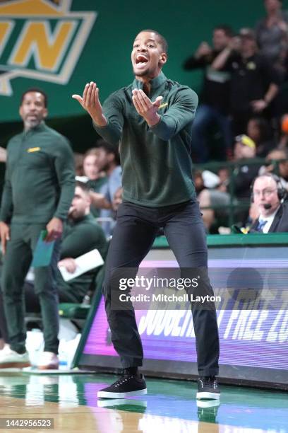 Head coach Kim English of the George Mason Patriots signals to his players during a college basketball game against the American University Eagles at...