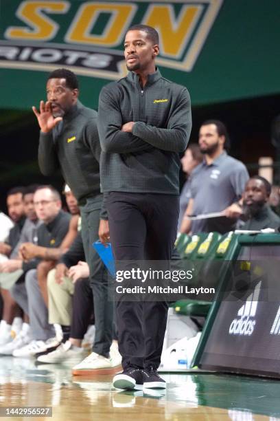 Head coach Kim English of the George Mason Patriots looks on during a college basketball game against the American University Eagles at Eagle Bank...