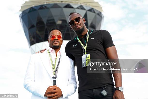 Patrice Evra and Usain Bolt pose for a photo prior to the F1 Grand Prix of Abu Dhabi at Yas Marina Circuit on November 20, 2022 in Abu Dhabi, United...
