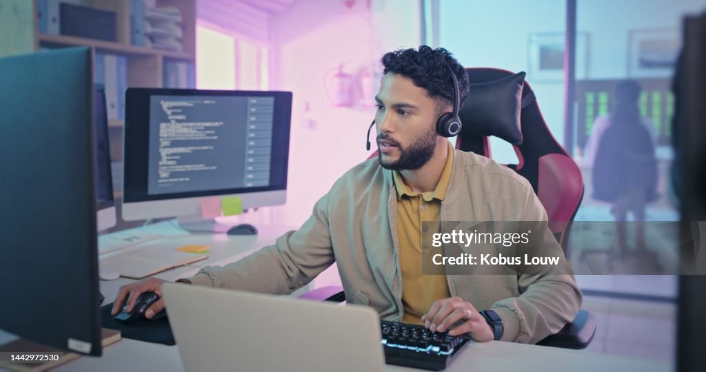 Gamer, software development and computer man in creative business with coding innovation, solution and information technology. Multimedia neon office, futuristic and gaming geek with code web design