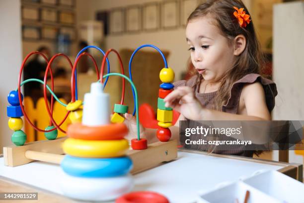 portrait cute preschool age boy playing with bead puzzle - small smart girl stock pictures, royalty-free photos & images