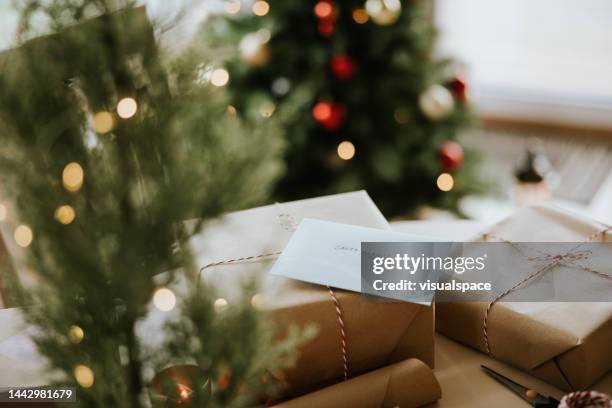 still life of christmas presents and a letter to santa clause - holiday message stock pictures, royalty-free photos & images