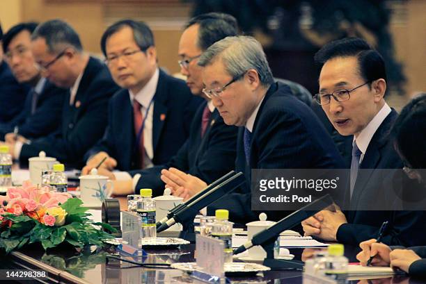 South Korea's President Lee Myung-bak talks at a bilateral meeting with China's Premier Wen Jiabao during the fifth trilateral summit among China,...