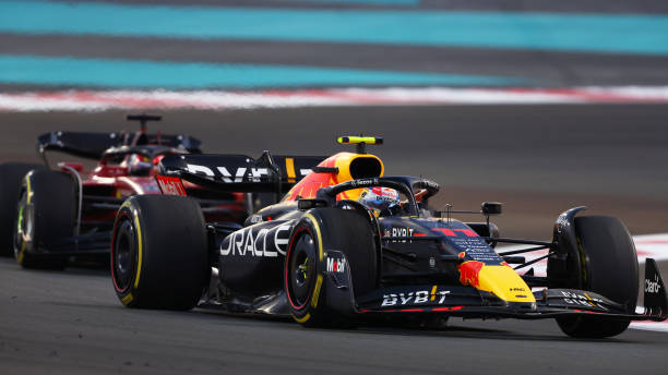 ABU DHABI F1 GP UNITED ARAB EMIRATES - NOVEMBER 20: Mexico's Sergio Perez driving the (11) Oracle Red Bull Racing RB18 ahead of Monaco's Charles Leclerc driving the (16) Ferrari F1-75 at the F1 Grand Prix On track during the Abu Dhabi Circuit on November 20, 2022 at the Yas Marina Circuit in Abu Dhabi, United Arab Emirates. 