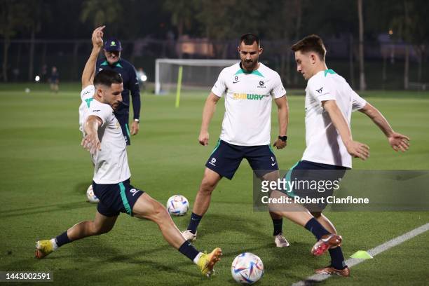 Mathew Leckie and Joel King of Australia compete for the ball during the Australian training session at the Aspire Training Ground on November 20,...