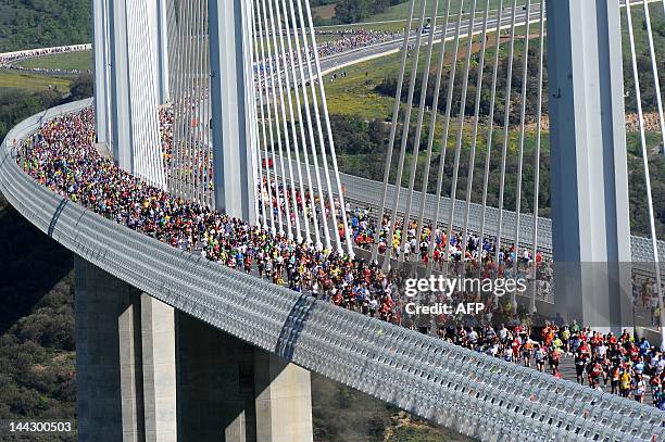 Some of the 13.500 competitors cross the Millau bridge as they take part in the "Viaduc de Millau" race, a 23.7 kilometers long race on May 13, 2012...