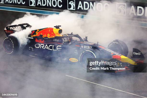 Race winner Max Verstappen of the Netherlands driving the Oracle Red Bull Racing RB18 performs a celebratory donut during the F1 Grand Prix of Abu...