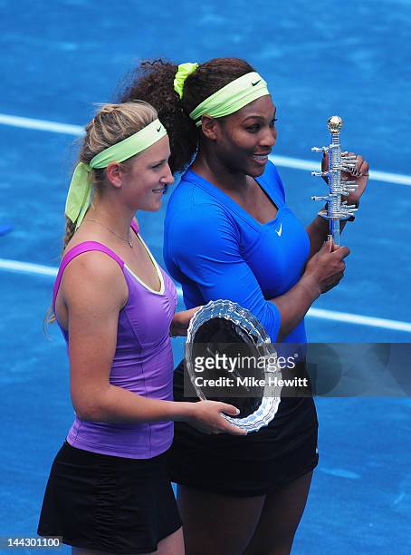 Serena Williams of USA holds the winner's trophy and Victoria Azarenka of Belarus the runners up trophy after the Womens' Singles Final on Day Nine...
