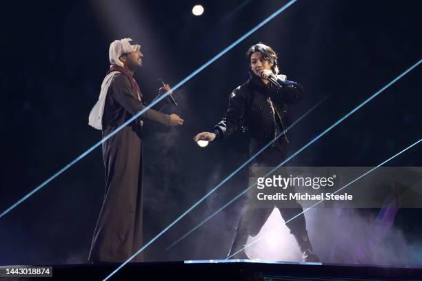 Jung Kook of BTS performs with Fahad Al Kubaisi during the opening ceremony prior to the FIFA World Cup Qatar 2022 Group A match between Qatar and...