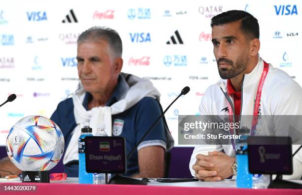 Iran head coach Carlos Queiroz speaks to the media with captain Ehsan Hajisafi ahead of the England game during Iran MD-1 Press Conference at the...
