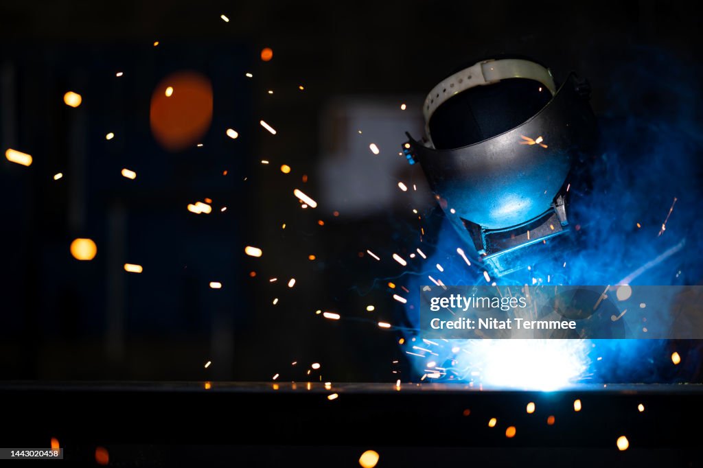 Welder Skills in the Metal Fabrication Industry. African American Welder working in a metal manufacturing facility to build structures, equipment, and engineering components.