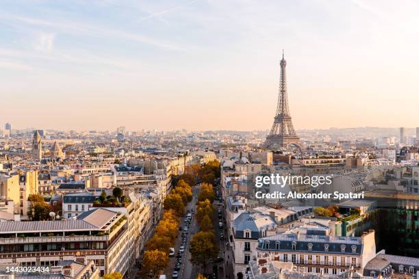 paris skyline with eiffel tower at sunset, aerial view, france - paris skyline photos et images de collection