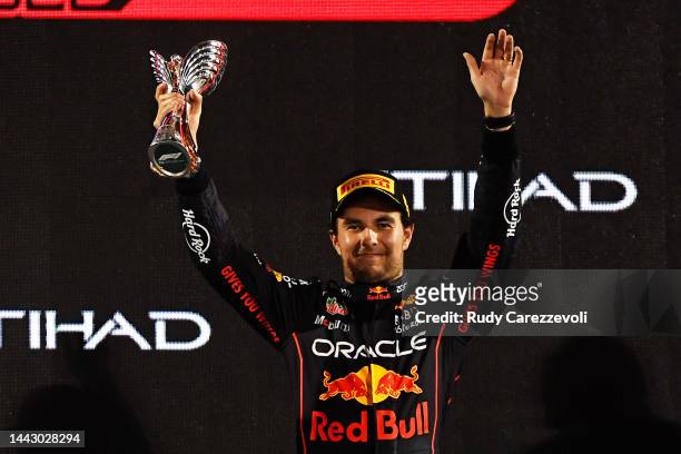 Third placed Sergio Perez of Mexico and Oracle Red Bull Racing celebrate on the podium during the F1 Grand Prix of Abu Dhabi at Yas Marina Circuit on...