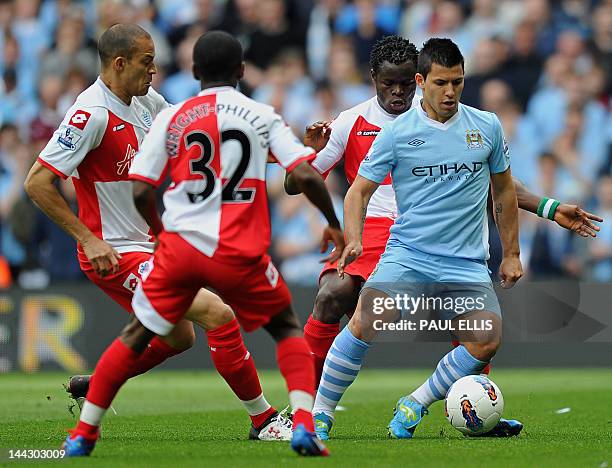 Manchester City's Argentinian striker Sergio Aguero surrounded by Queens Park Rangers players, Taye Taiwo , Shaun Wright-Phillips and Bobby Zamora...