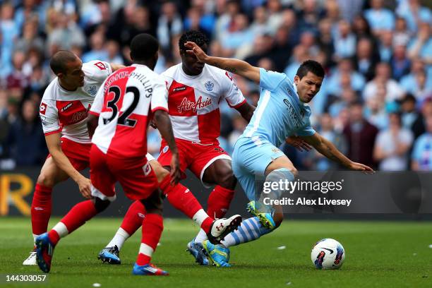 Sergio Aguero of Manchester City is closed down by the QPR defence during the Barclays Premier League match between Manchester City and Queens Park...