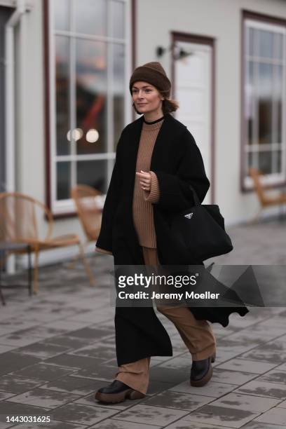 Mie Juel is seen wearing Copenhagen Studios CPH276 vitello black/nut brown boots, By Malene Birger black wool coat, Closed beige(brown pants, Ganni...