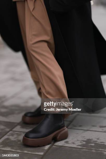 Mie Juel is seen wearing Copenhagen Studios CPH276 vitello black/nut brown boots, By Malene Birger black wool coat, Closed beige(brown pants and...