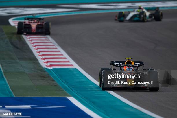 Sergio Perez of Mexico driving the Oracle Red Bull Racing RB18 leads Charles Leclerc of Monaco driving the Ferrari F1-75 on track during the F1 Grand...