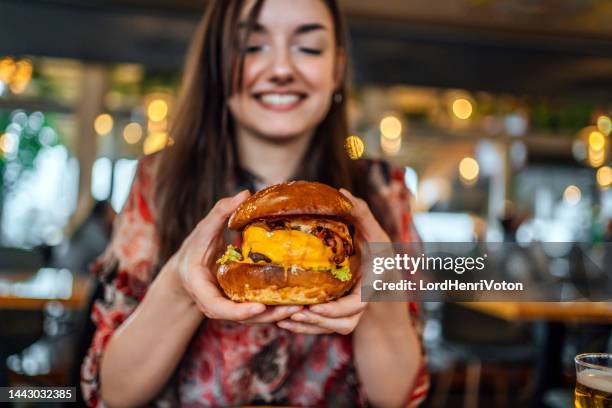 young woman ready to eat a burger - eating cheeseburger stock pictures, royalty-free photos & images
