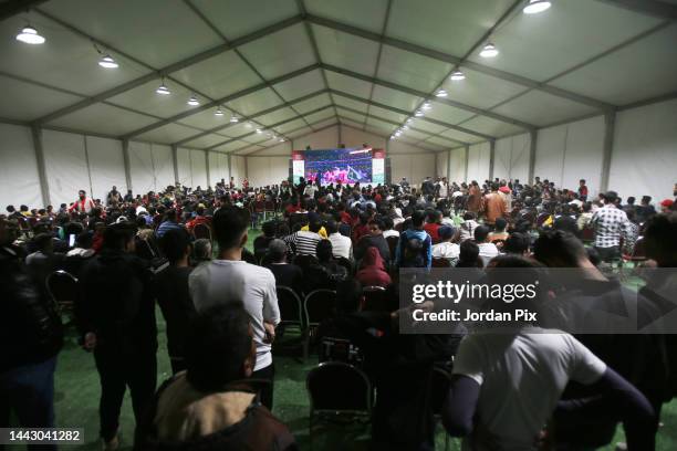 Syrian refugees watch the opening ceremony of the Qatar 2022 World Cup and the first match on November 20, 2022 at the Zaatari refugee camp near...