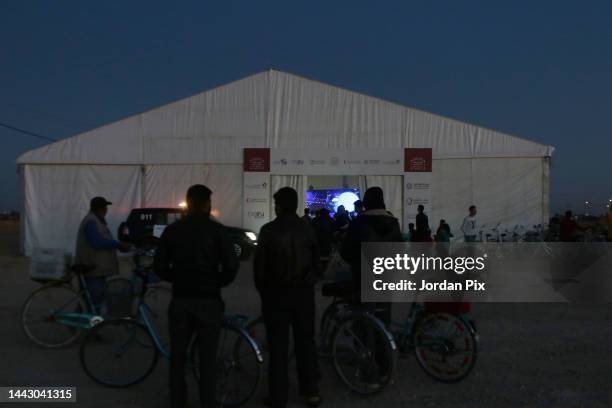 Syrian refugees watch the opening ceremony of the Qatar 2022 World Cup and the first match on November 20, 2022 at the Zaatari refugee camp near...