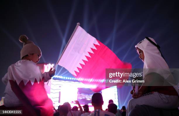 Fans wave a Qatar flag during day 2 of the FIFA World Cup 2022 Qatar Fan Festival at Al Bidda Park on November 20, 2022 in Doha, Qatar.