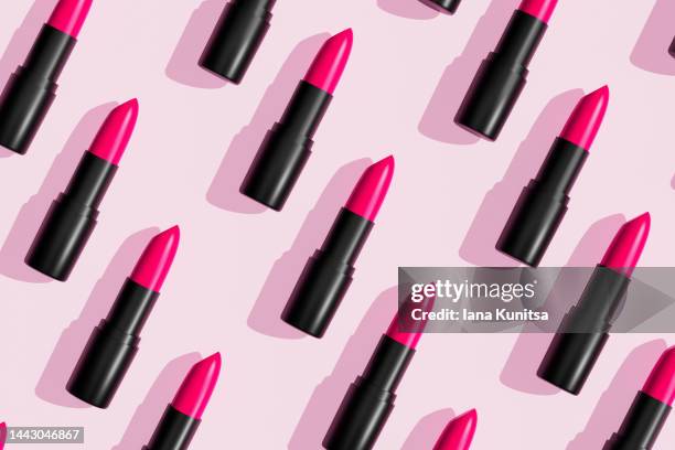 pink lipsticks, lip gloss on trendy pastel background. cosmetic products. makeup accessories. skin care. beauty 3d pattern. - lipstick bildbanksfoton och bilder