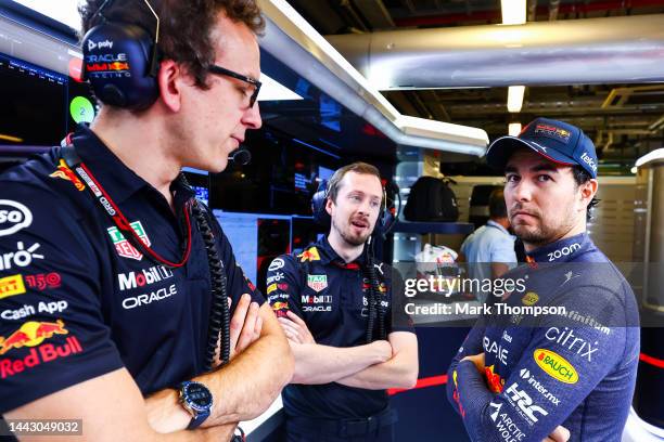 Sergio Perez of Mexico and Oracle Red Bull Racing looks on in the garage prior to the F1 Grand Prix of Abu Dhabi at Yas Marina Circuit on November...