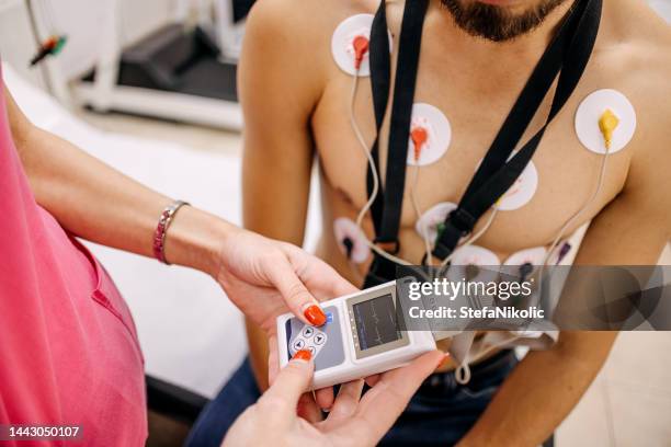 man with heart problems on the visit to doctor - heart monitor stock pictures, royalty-free photos & images