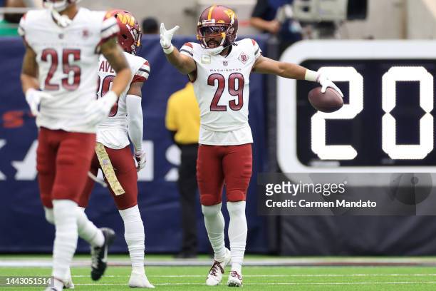 Kendall Fuller of the Washington Commanders celebrates after an interception for a touchdown in the first quarter of a game against the Houston...