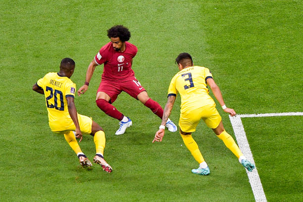 Akram Afif of Qatar battles for the ball with Jhegson Mendez of Ecuador and Piero Hincapie of Ecuador during the Group A - FIFA World Cup Qatar 2022...