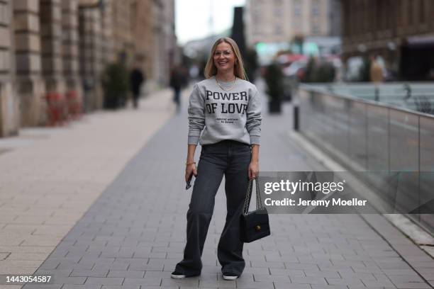 Julia Conrad seen wearing a grey sweater, black Adidas sneaker, grey Zara jeans and black Chanel bag on November 18, 2022 in Hamburg, Germany.