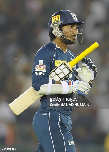 Deccan Chargers team captain and batsman Kumar Sangakkara walks to the pavilion following his dismissal during the IPL Twenty20 cricket match between...