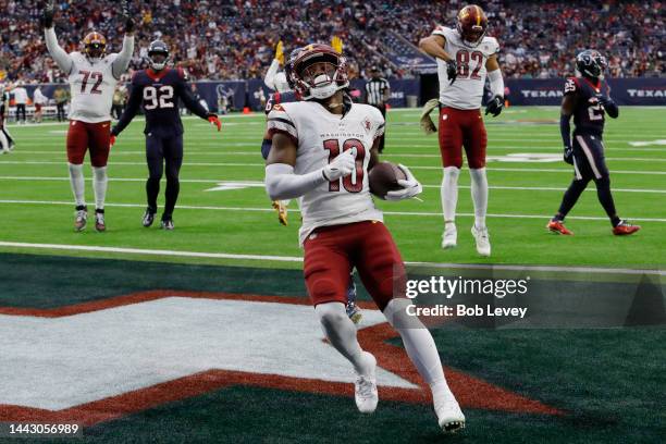 Curtis Samuel of the Washington Commanders scores a rushing touchdown in the second quarter of a game against the Houston Texans at NRG Stadium on...