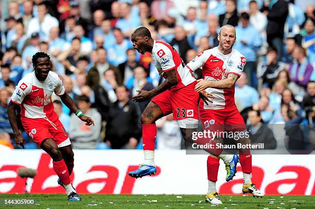 Djibril Cisse of QPR celebrates with teammate Taye Taiwo and Shaun Derry after scoring his team's first goal during the Barclays Premier League match...