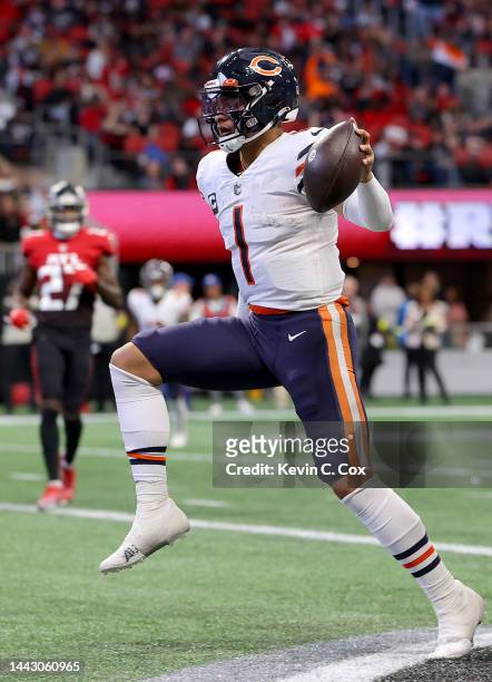 Justin Fields of the Chicago Bears celebrates after scoring a touchdown during the second quarter against the Atlanta Falcons at Mercedes-Benz...