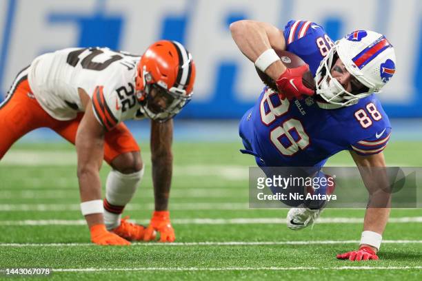 Dawson Knox of the Buffalo Bills dives forward after being hit by Grant Delpit of the Cleveland Browns during the second quarter at Ford Field on...