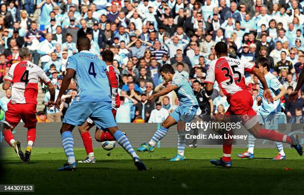 Sergio Aguero of Manchester City scores his team's third and matchwinning goal during the Barclays Premier League match between Manchester City and...