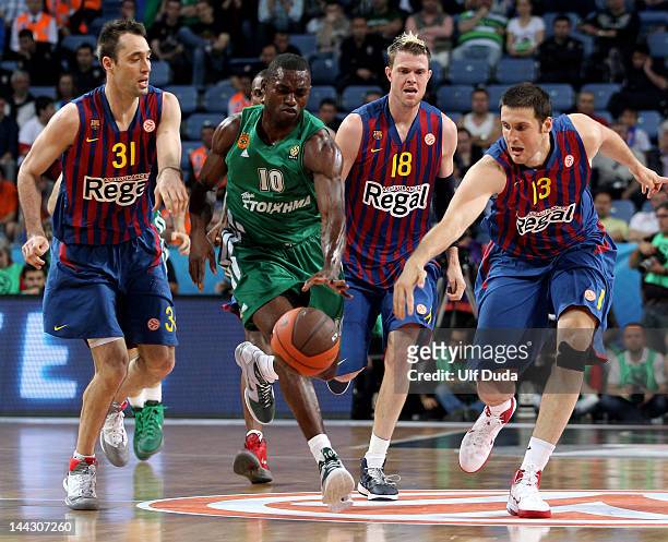 Romain Sato, #10 of Panathinaikos Athens competes with Kosta Perovic, #13 of FC Barcelona Regal during the Turkish Airlines EuroLeague Final Four...