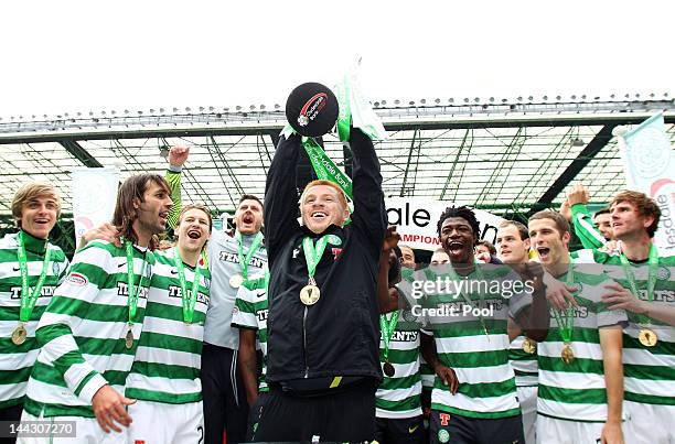 Neil Lennon coach of Celtic lifts the Clydesdale Bank Premier League trophy following the Clydesdale Bank Premier League match between Celtic and...