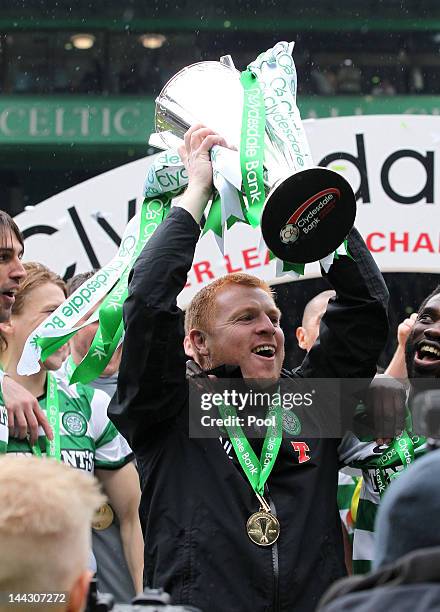 Neil Lennon coach of Celtic lifts the Clydesdale Bank Premier League trophy following the Clydesdale Bank Premier League match between Celtic and...